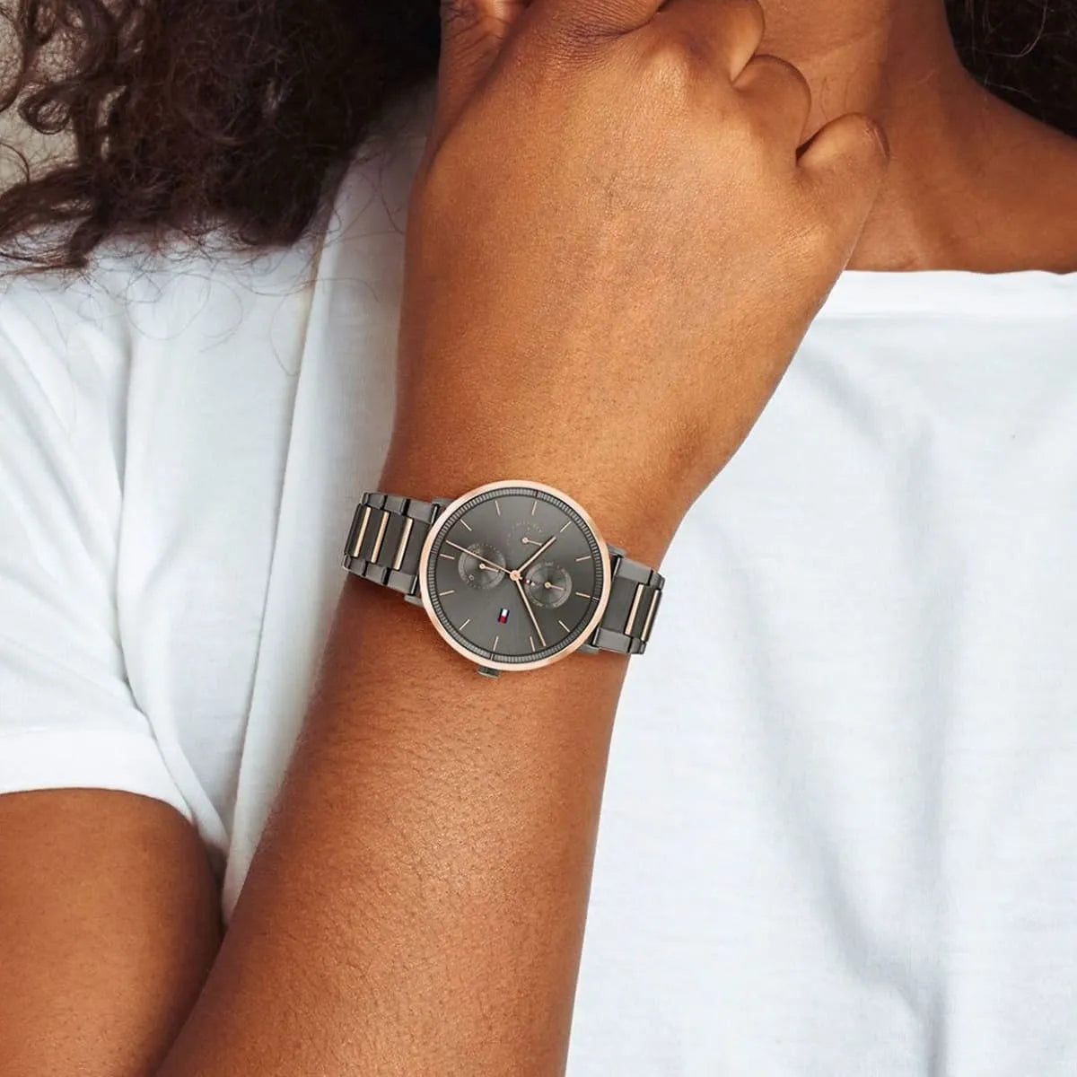 Woman wearing Tommy Hilfiger Jenna chronograph watch with gray dial
