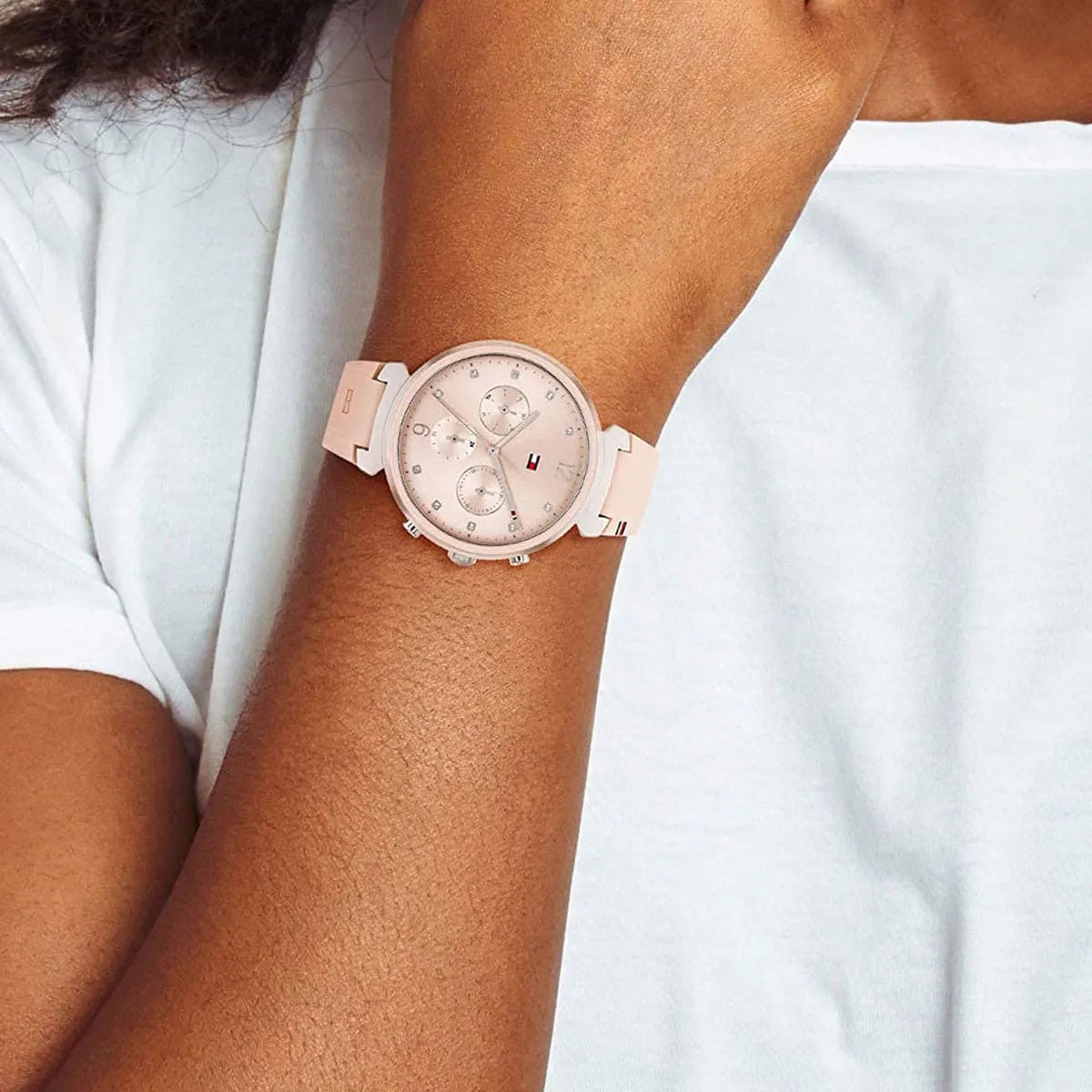 Lifestyle image of Tommy Hilfiger women's watch with pink dial on wrist
