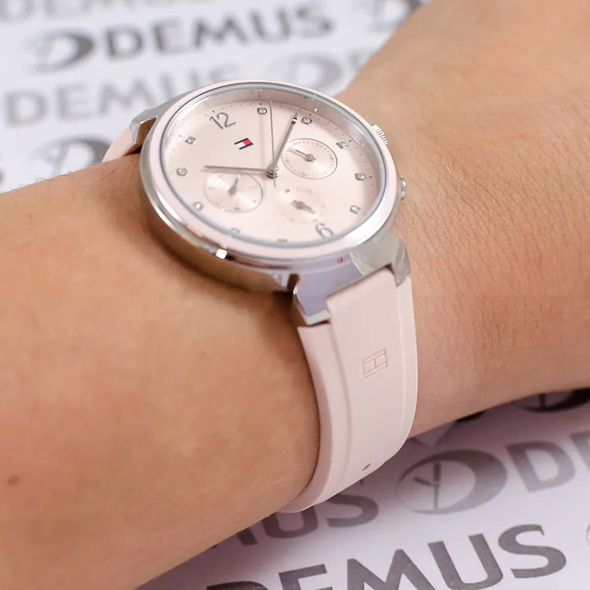 Tommy Hilfiger women's watch worn on wrist showing pink dial and chronograph