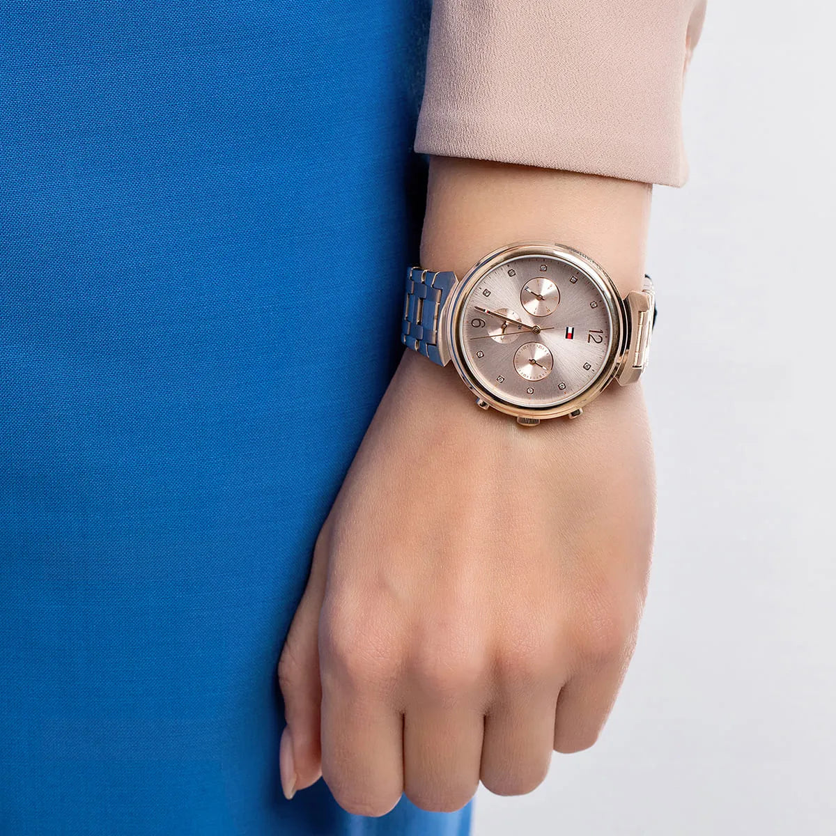 Tommy Hilfiger Ivy multifunction watch on wrist showing pink dial and rose gold bracelet