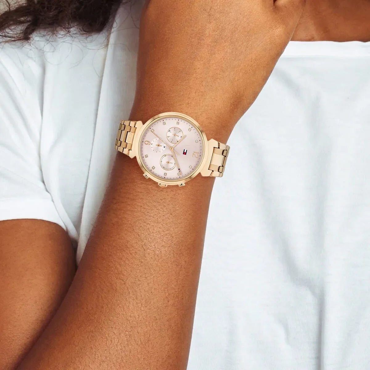 Tommy Hilfiger Ivy women's chronograph watch on wrist with pink dial and rose gold bracelet