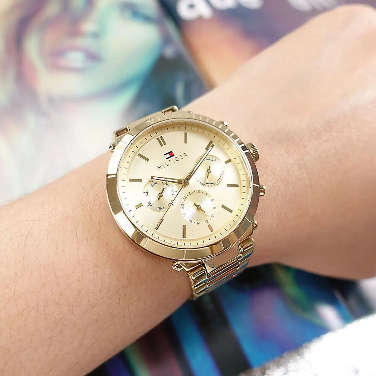 Tommy Hilfiger Emery gold watch worn on wrist with cream dial and chronograph subdials