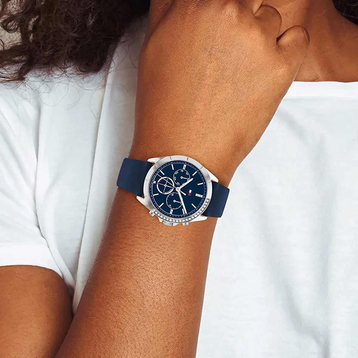 Tommy Hilfiger Kennedy watch worn on wrist with navy strap and chronograph functions