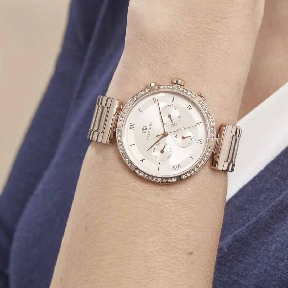 Rose gold Tommy Hilfiger women's watch worn on wrist showing full dial and bracelet