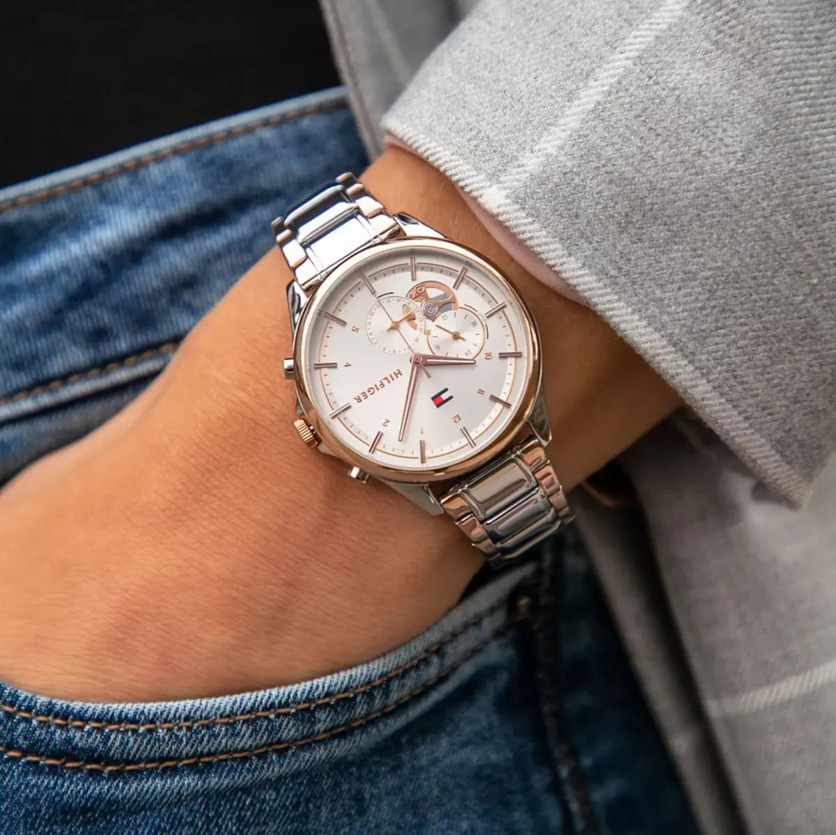 Tommy Hilfiger Quinn watch worn on wrist showing silver dial and two-tone bracelet