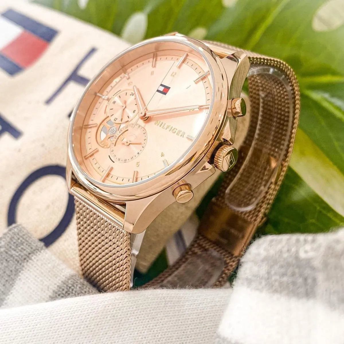 Tommy Hilfiger Quinn watch on fabric background showing dial detail and rose gold case
