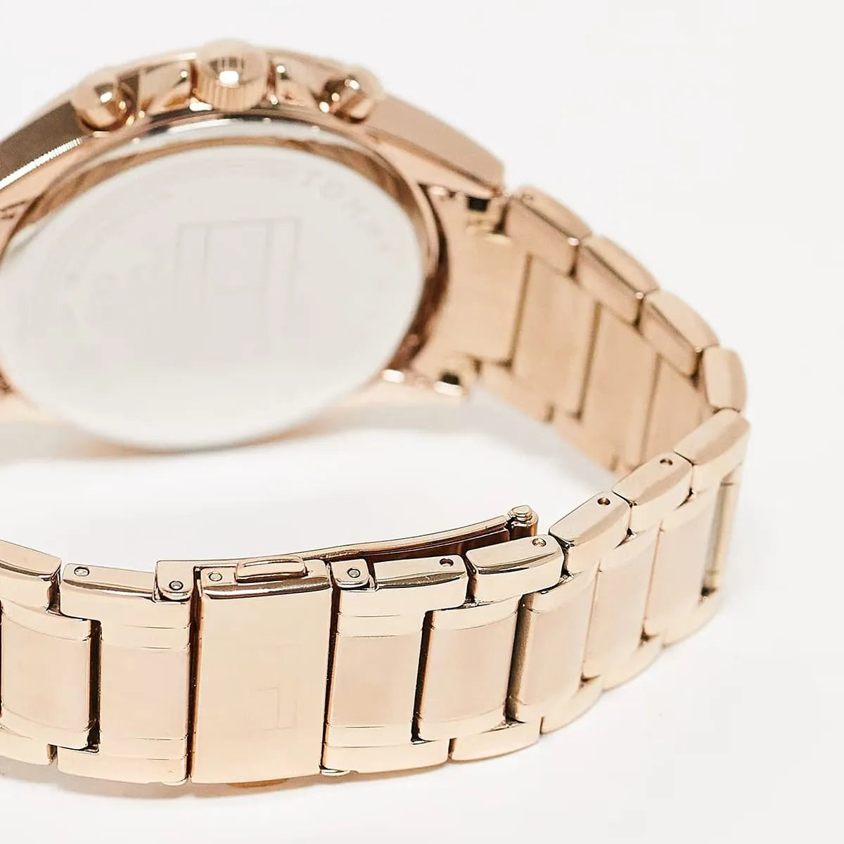 Close-up of Tommy Hilfiger rose gold stainless steel bracelet showing link detail and clasp