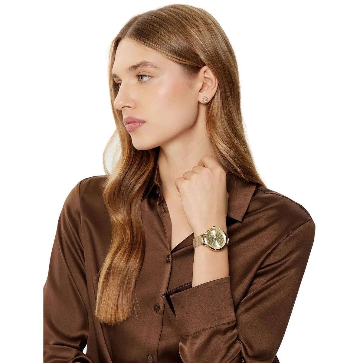 Gold Tommy Hilfiger slim watch with champagne dial worn on woman's wrist
