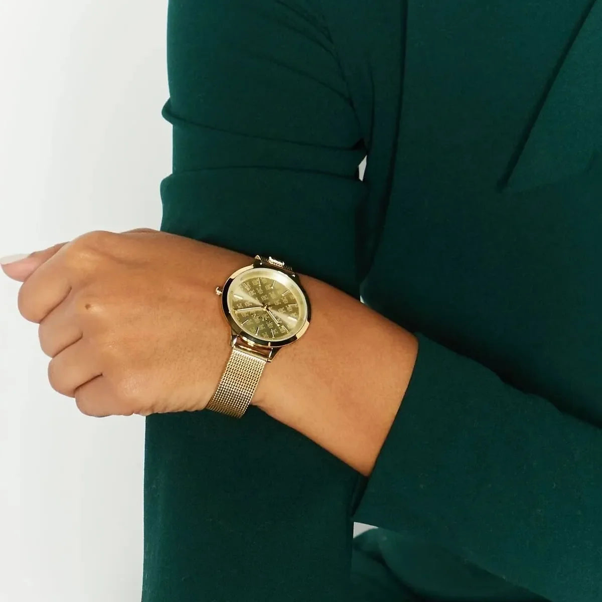 Tommy Hilfiger women's gold watch with mesh strap styled on wrist