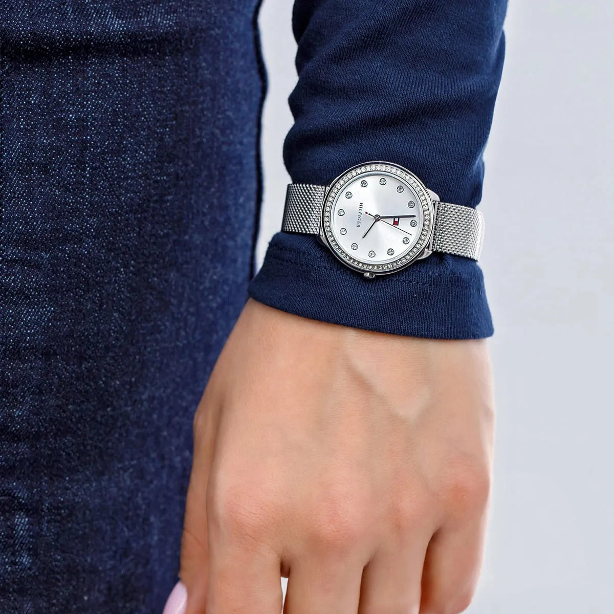 Tommy Hilfiger silver watch worn on wrist with crystal dial visible