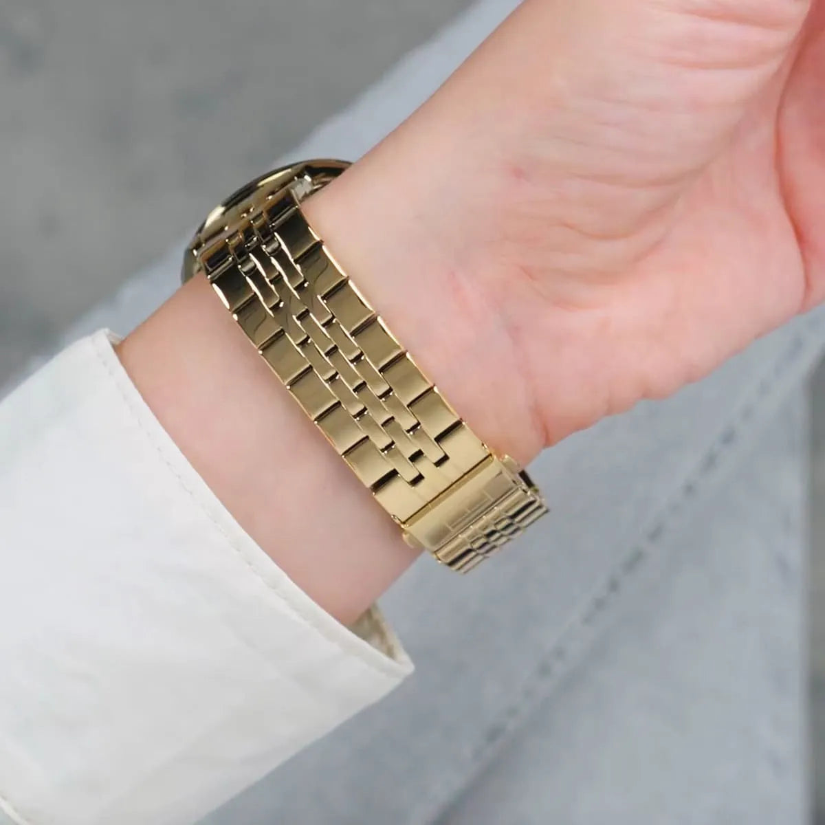 Close-up of Tommy Hilfiger Monica gold plated metal bracelet strap on wrist