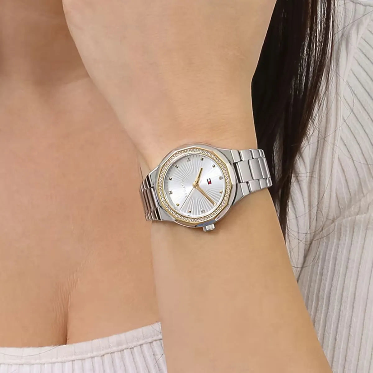 Tommy Hilfiger women's watch worn on wrist showing silver dial and stainless steel bracelet