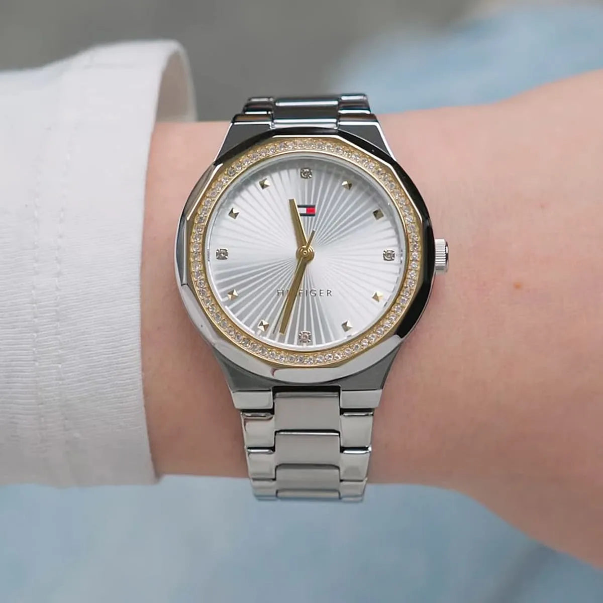 Tommy Hilfiger women's watch on wrist with crystal bezel and stainless steel metal strap