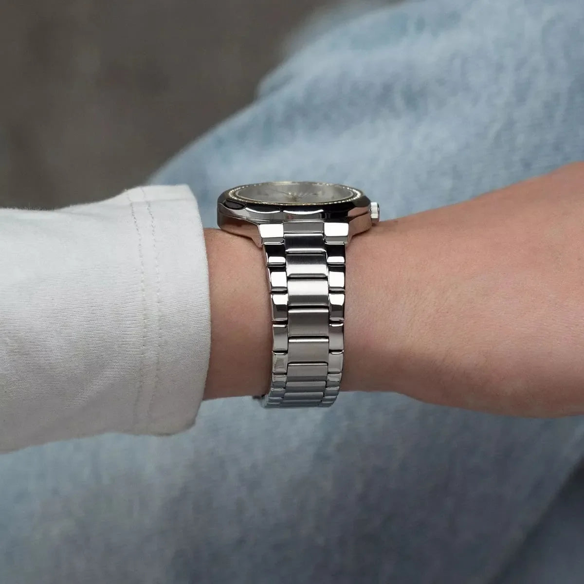 Side view of Tommy Hilfiger women's watch on wrist showing stainless steel metal bracelet strap
