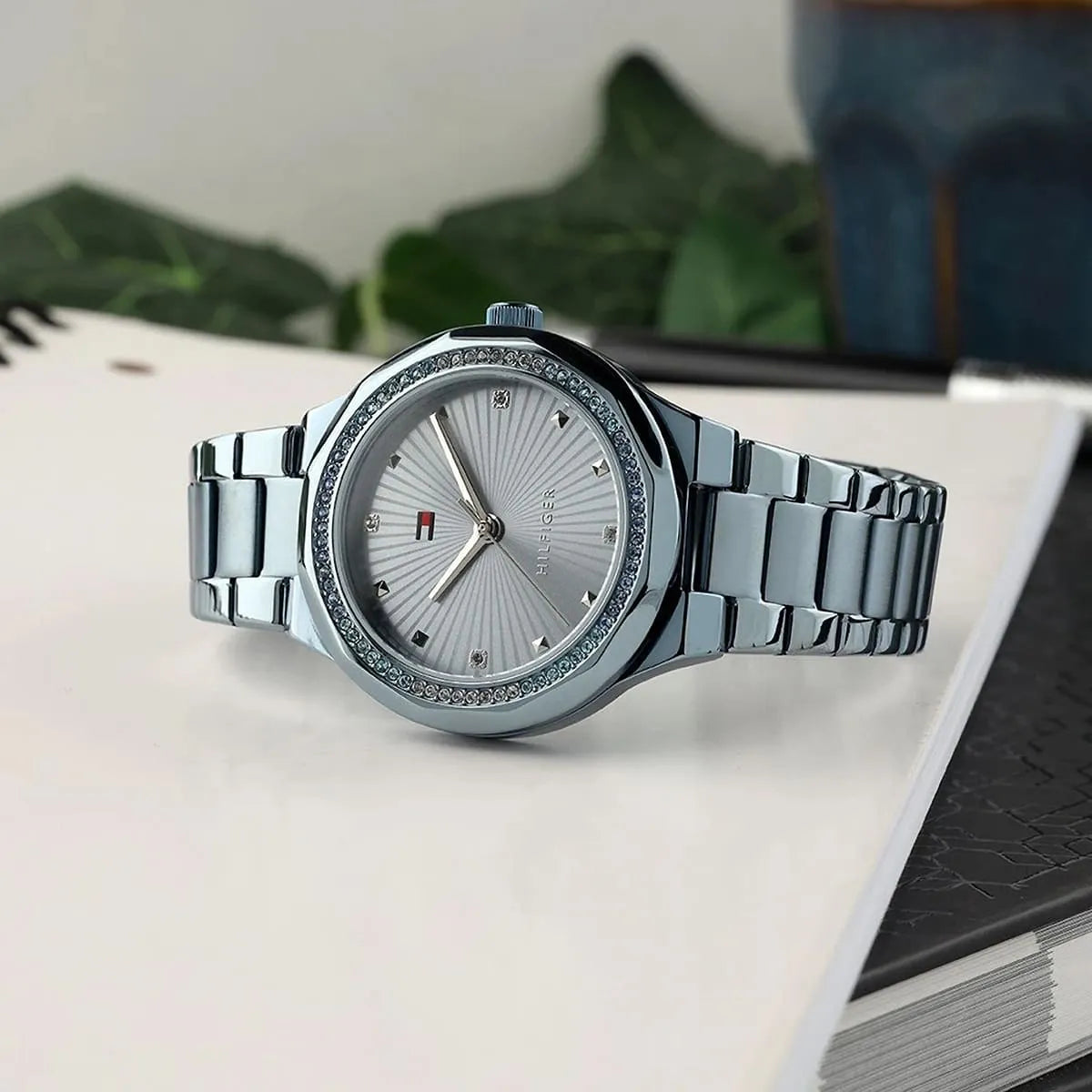 Tommy Hilfiger Piper ladies watch on white surface showing watch face and metal strap
