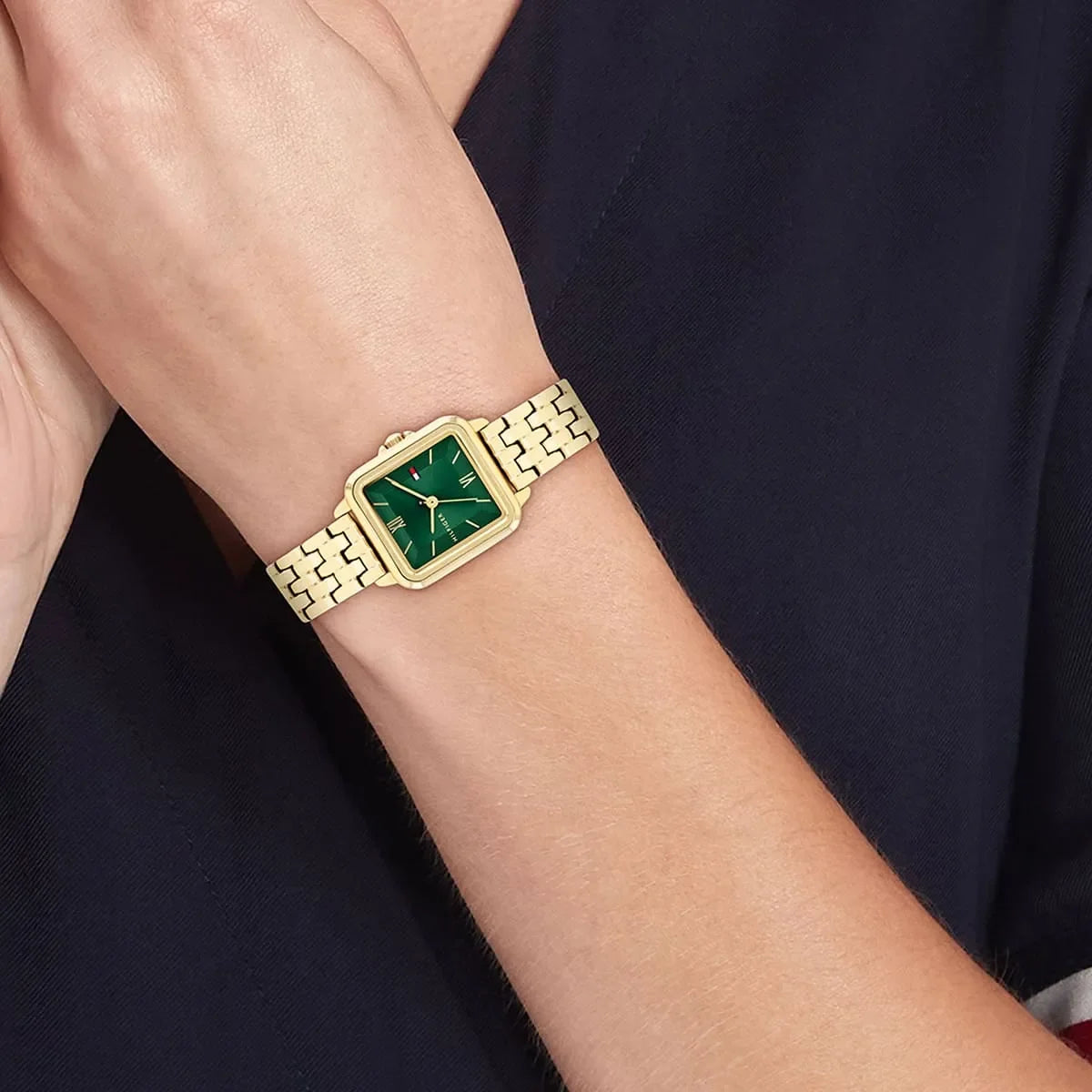 Tommy Hilfiger Mia gold watch worn on wrist showing green dial and bracelet
