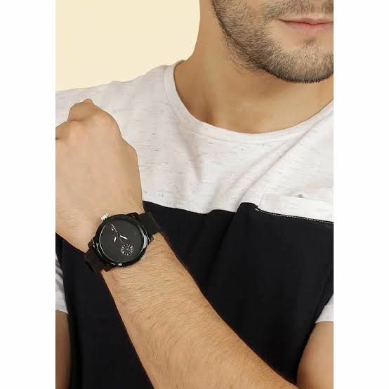 Tommy Hilfiger Denim watch worn on man's wrist with black rubber strap