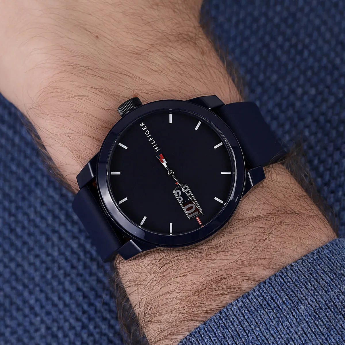 On-wrist view of Tommy Hilfiger men's watch with blue dial and navy rubber strap