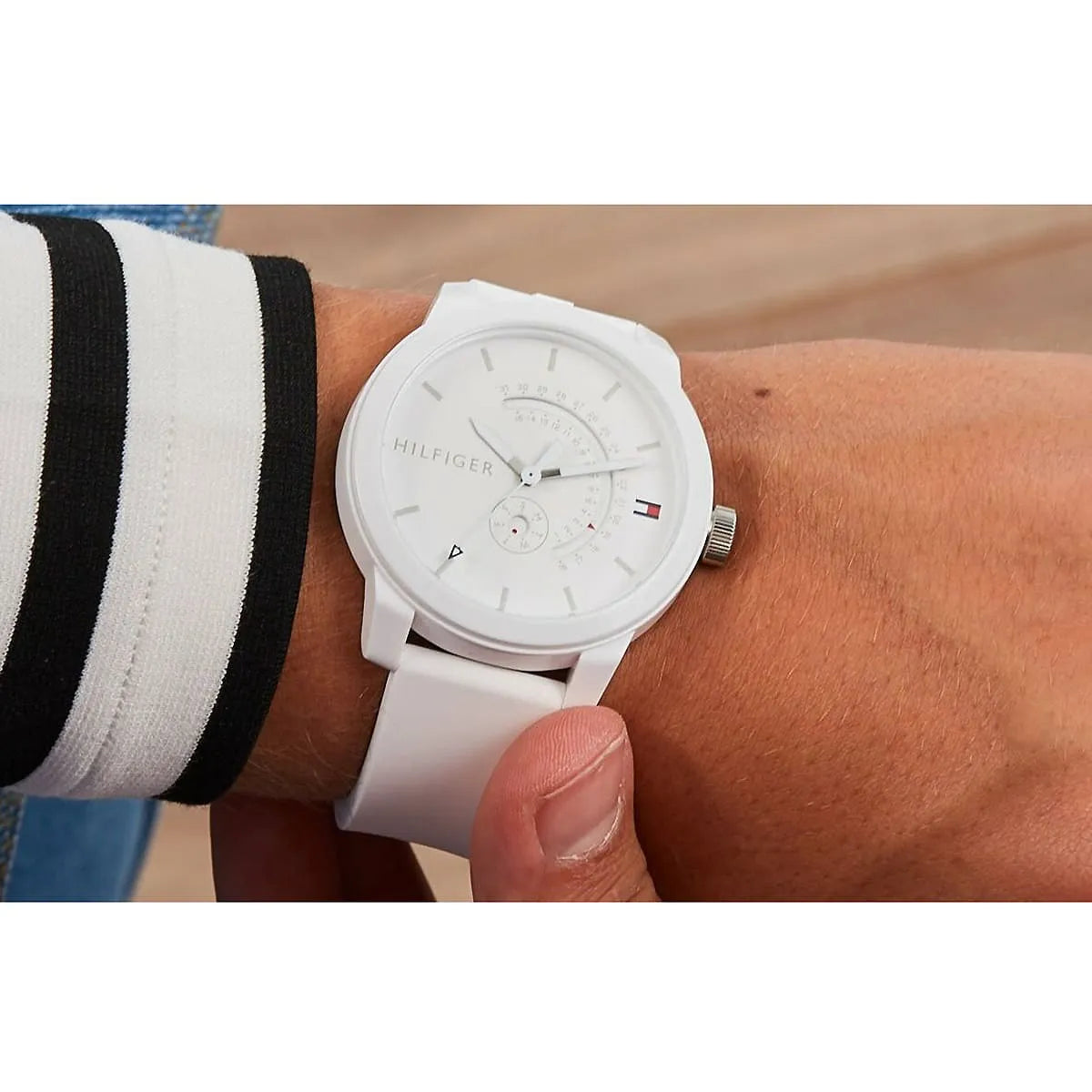 Tommy Hilfiger Denim white men's watch on wrist showing silicone strap and white dial