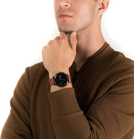Tommy Hilfiger James watch on wrist showing black dial and brown leather strap