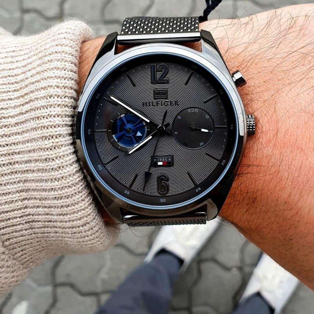 Tommy Hilfiger Deacan watch worn on wrist with black mesh strap