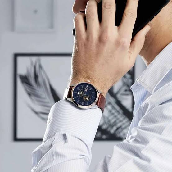 Tommy Hilfiger Spencer watch worn on wrist showing blue dial and brown leather strap