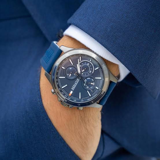 Tommy Hilfiger 1791721 chronograph watch worn on wrist with blue rubber strap