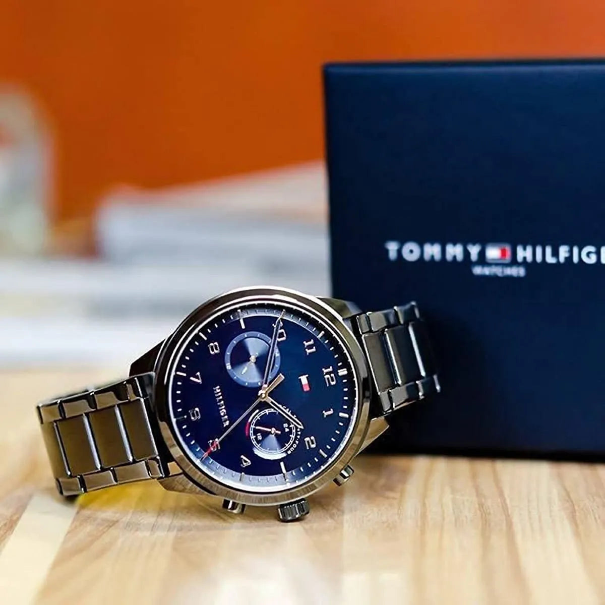 Tommy Hilfiger Patrick watch with blue dial displayed next to branded packaging box