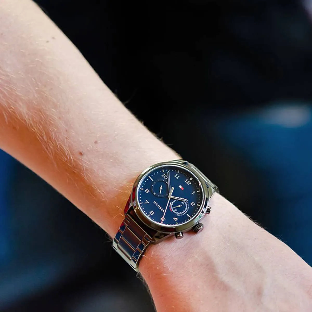 Tommy Hilfiger Patrick chronograph watch on wrist showing blue dial and stainless steel bracelet