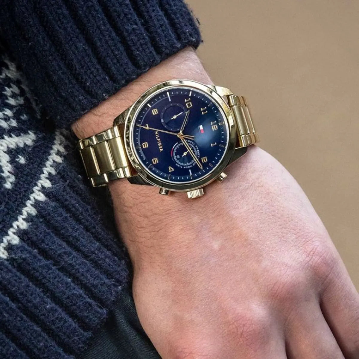 Tommy Hilfiger Patrick watch worn on wrist with blue dial and metal bracelet