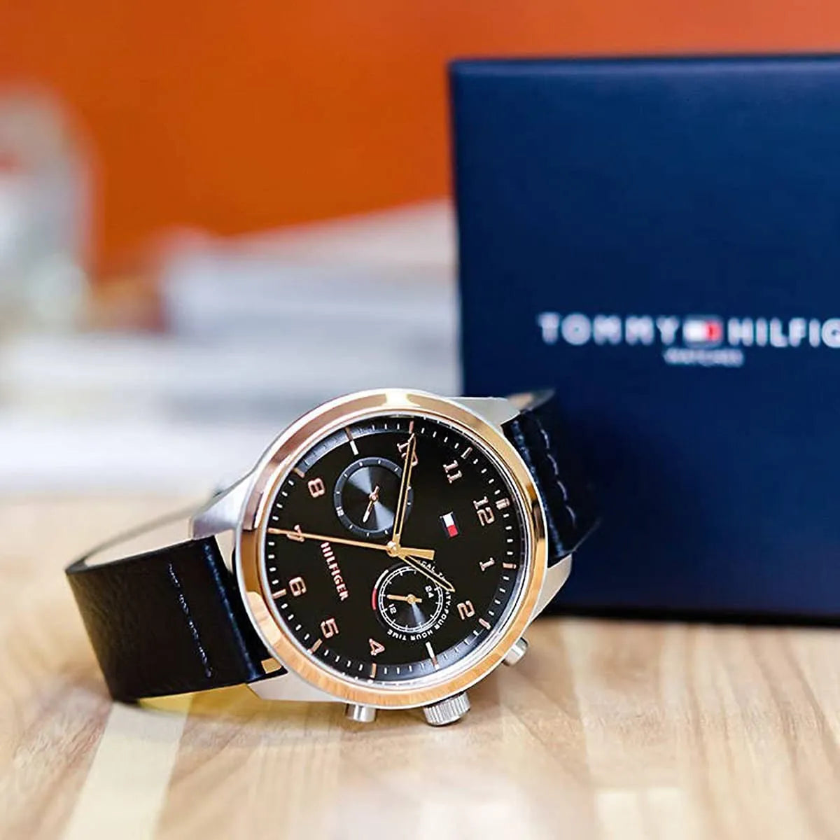 Tommy Hilfiger watch displayed with branded navy packaging box
