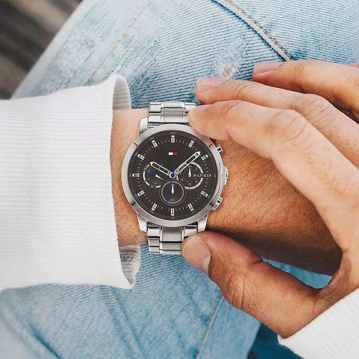 Tommy Hilfiger Jameson watch on wrist with denim and white shirt sleeves visible