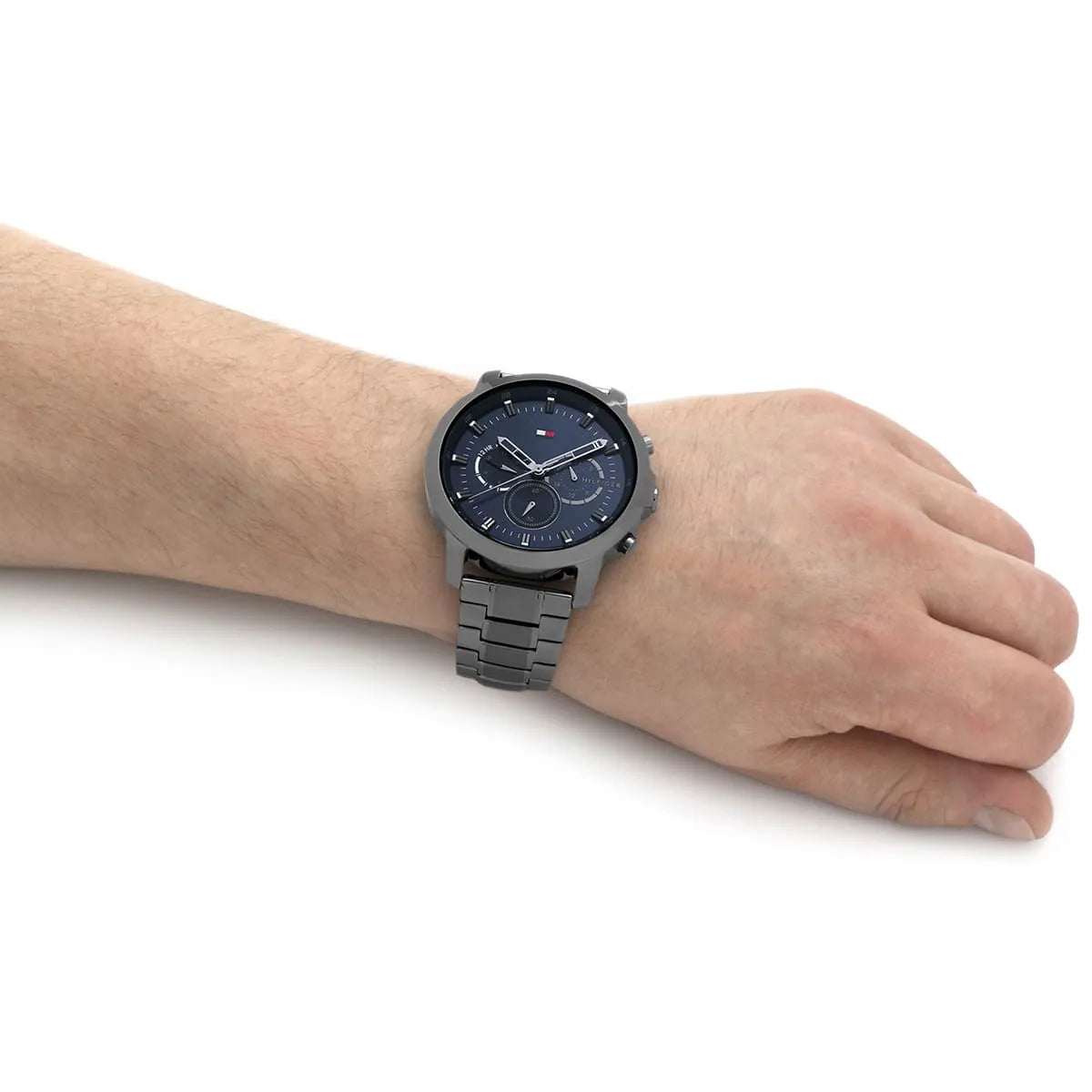 Tommy Hilfiger chronograph watch worn on wrist with blue dial and gray stainless steel bracelet