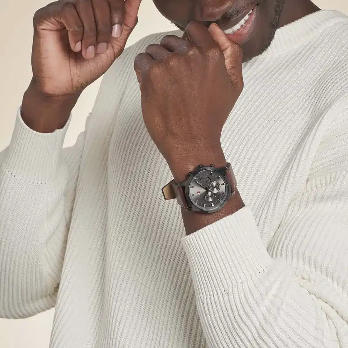 Tommy Hilfiger 1791799 chronograph watch on wrist with white ribbed sweater