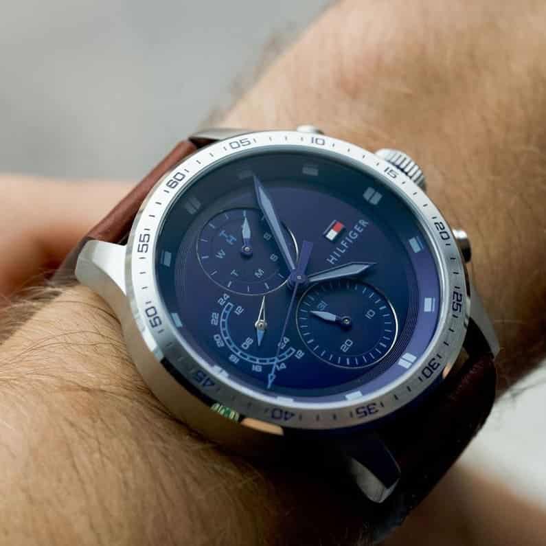 Tommy Hilfiger chronograph watch worn on wrist showing blue dial and steel case