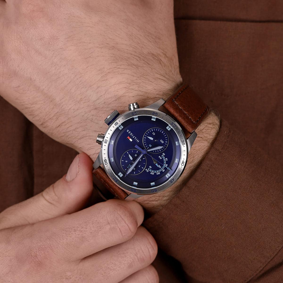 Tommy Hilfiger chronograph watch worn on wrist with dual subdials and steel case