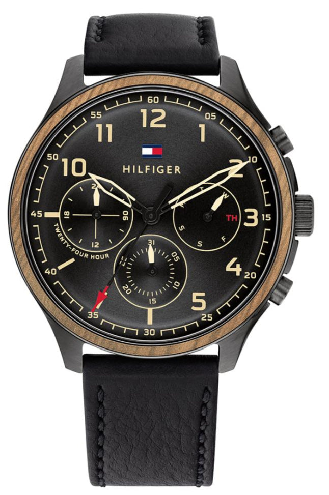 Tommy Hilfiger Asher chronograph watch with black dial, gold accents, leather strap, and three subdials