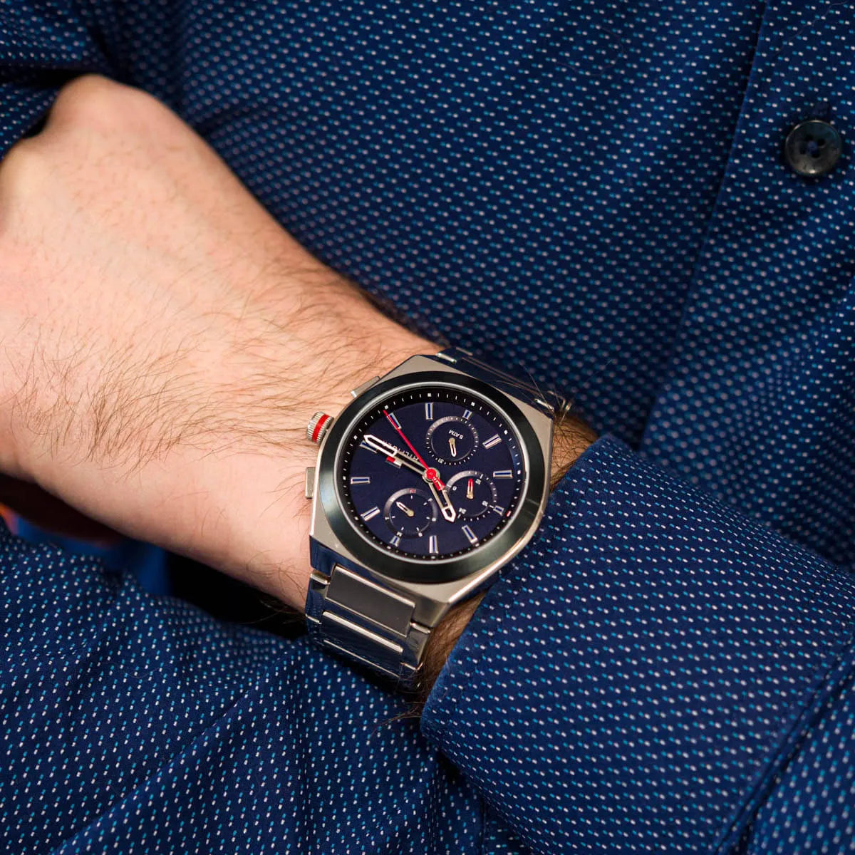 Tommy Hilfiger Connor watch on wrist showing blue chronograph dial and silver bracelet