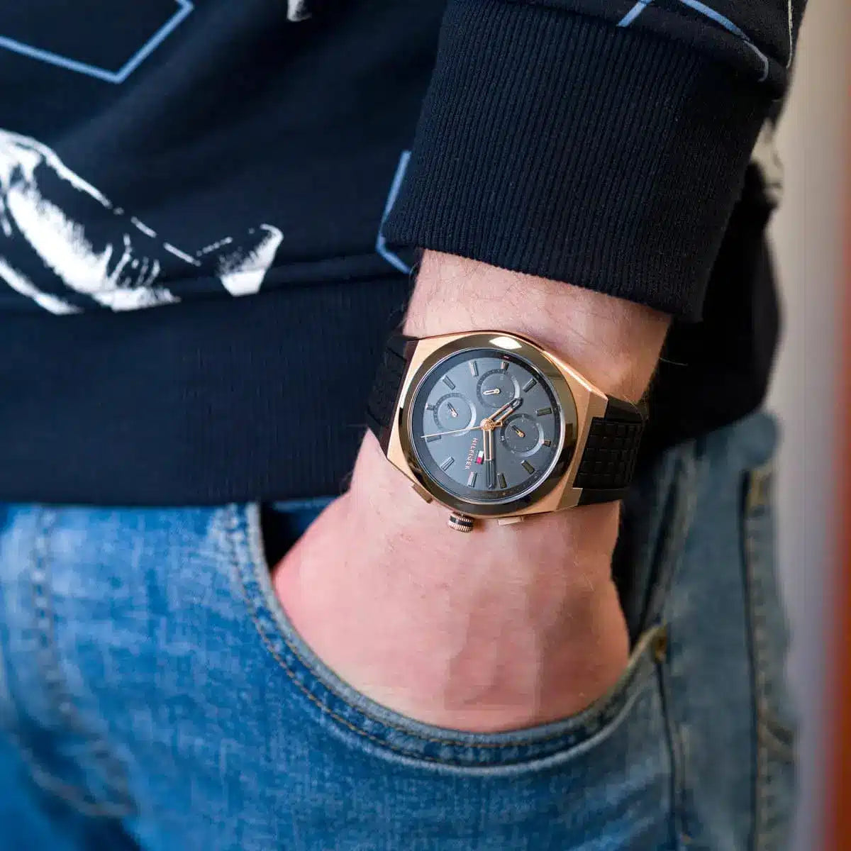 Tommy Hilfiger Connor watch on wrist showing blue dial with rose gold case detail