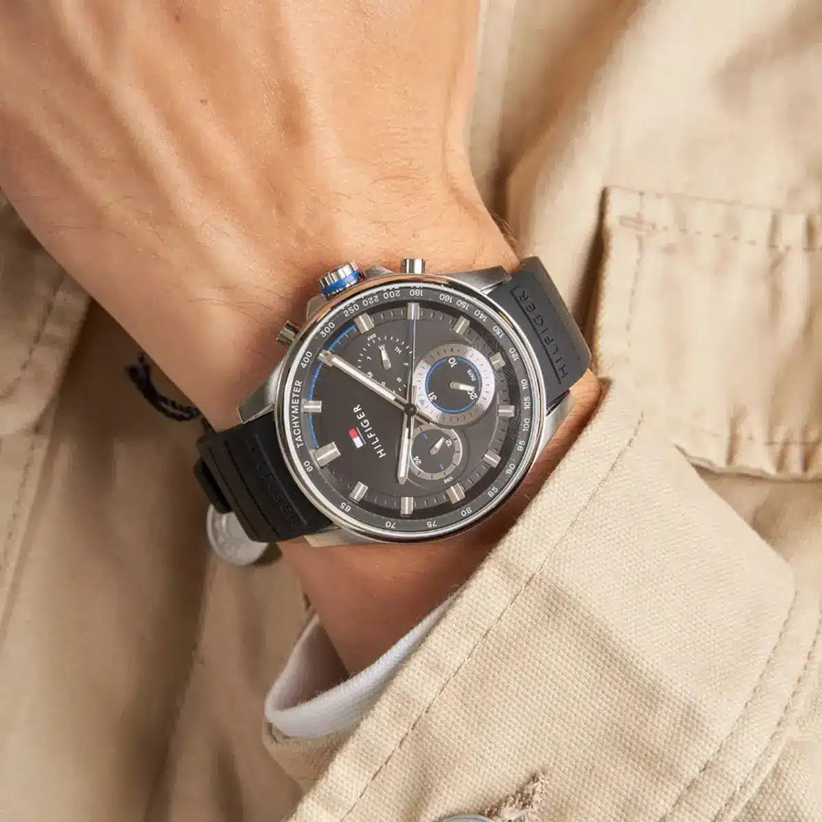 Tommy Hilfiger Max chronograph watch on wrist with silver case and black rubber strap