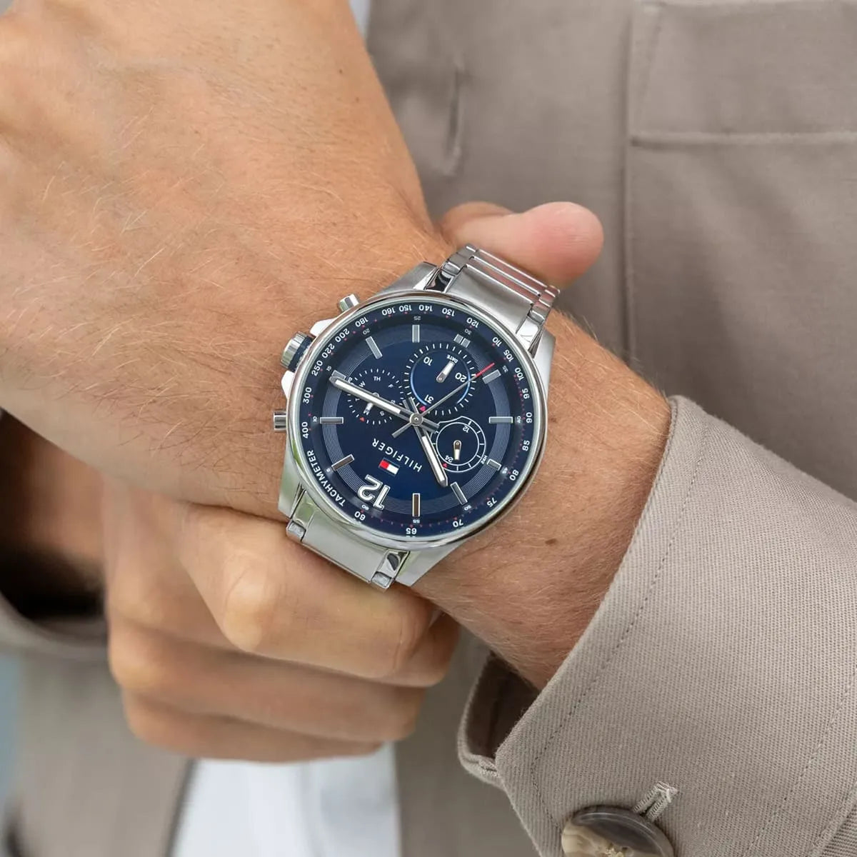 Tommy Hilfiger Max watch worn on wrist showing navy dial and metal strap