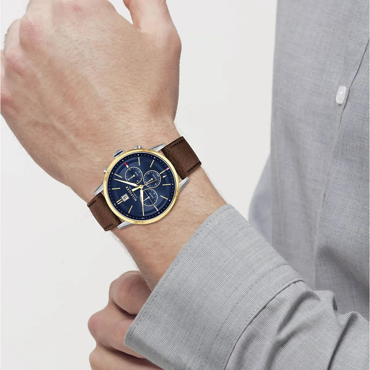 Tommy Hilfiger Kyle men's watch worn on wrist, blue dial with chronograph subdials visible