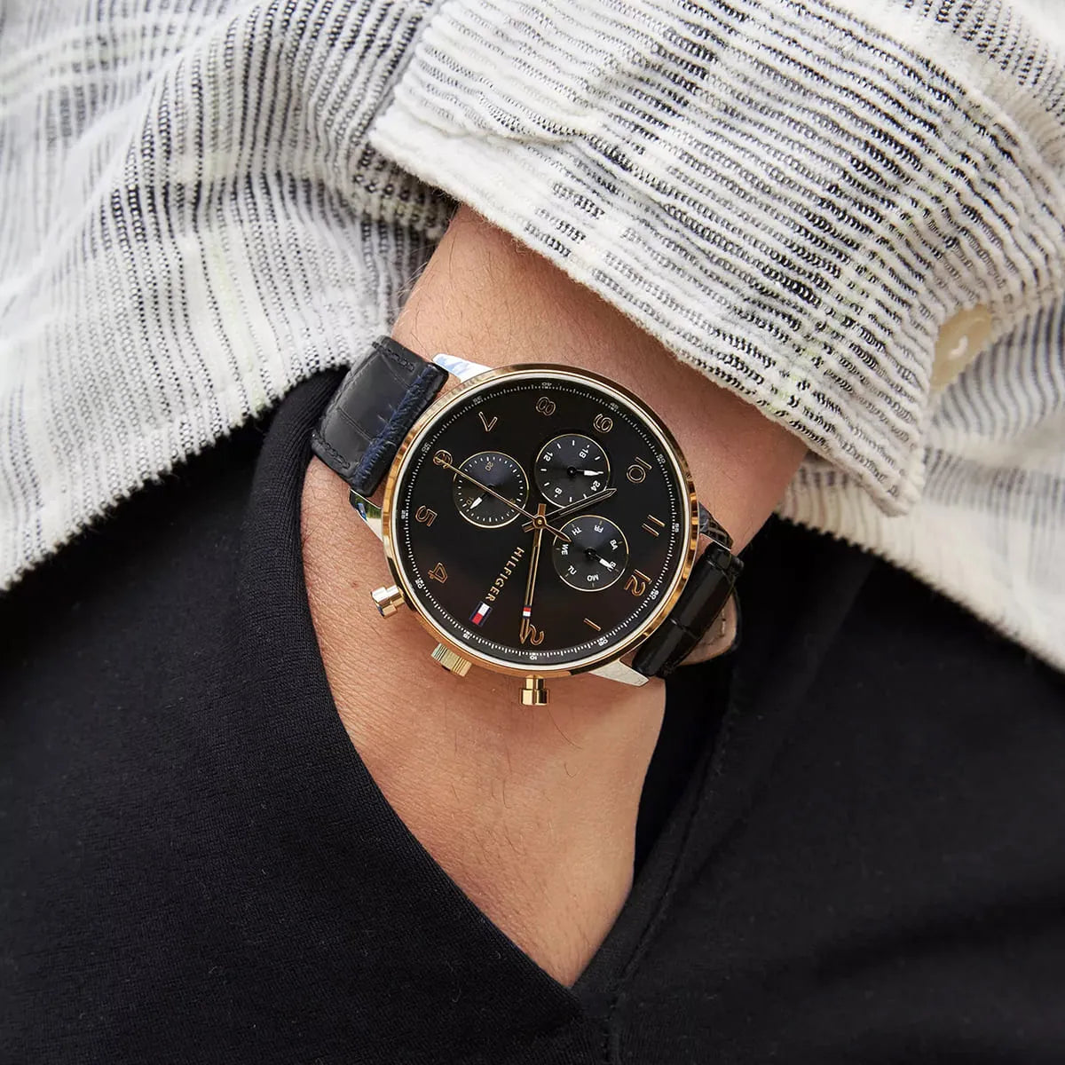 Tommy Hilfiger Leonard chronograph watch worn on wrist, showcasing the black dial and leather strap