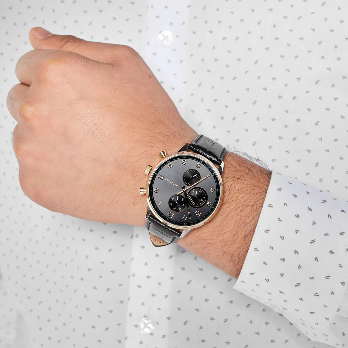 Tommy Hilfiger Leonard chronograph worn on wrist showing the complete dial design and black leather band