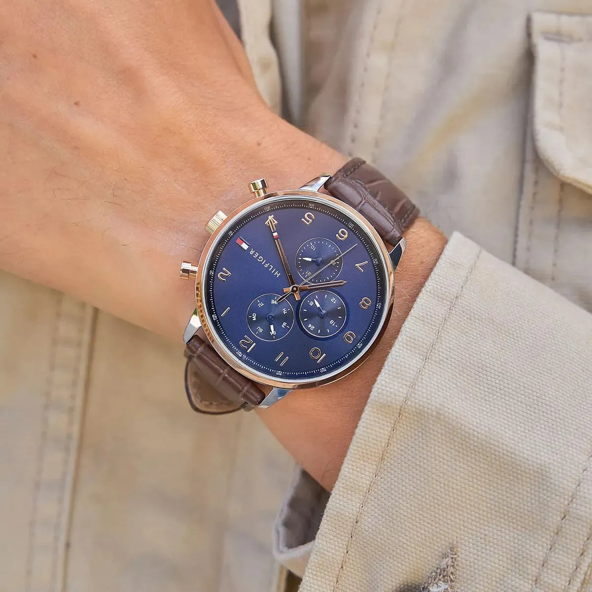 Tommy Hilfiger Leonard watch on wrist with blue dial and brown strap visible