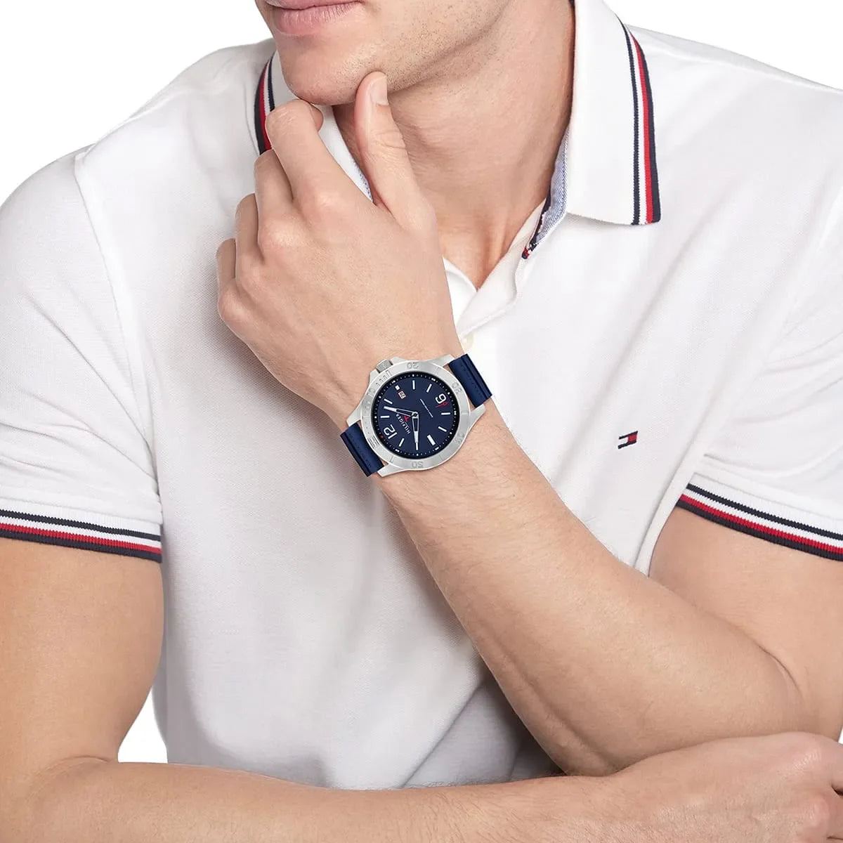 Tommy Hilfiger 1791991 men's watch worn on wrist with blue strap and blue dial visible