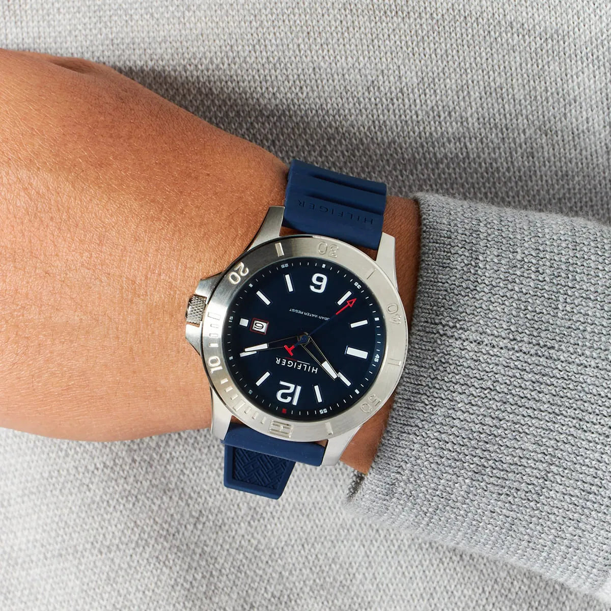 Tommy Hilfiger 1791991 watch worn on wrist, displaying blue dial and stainless steel case