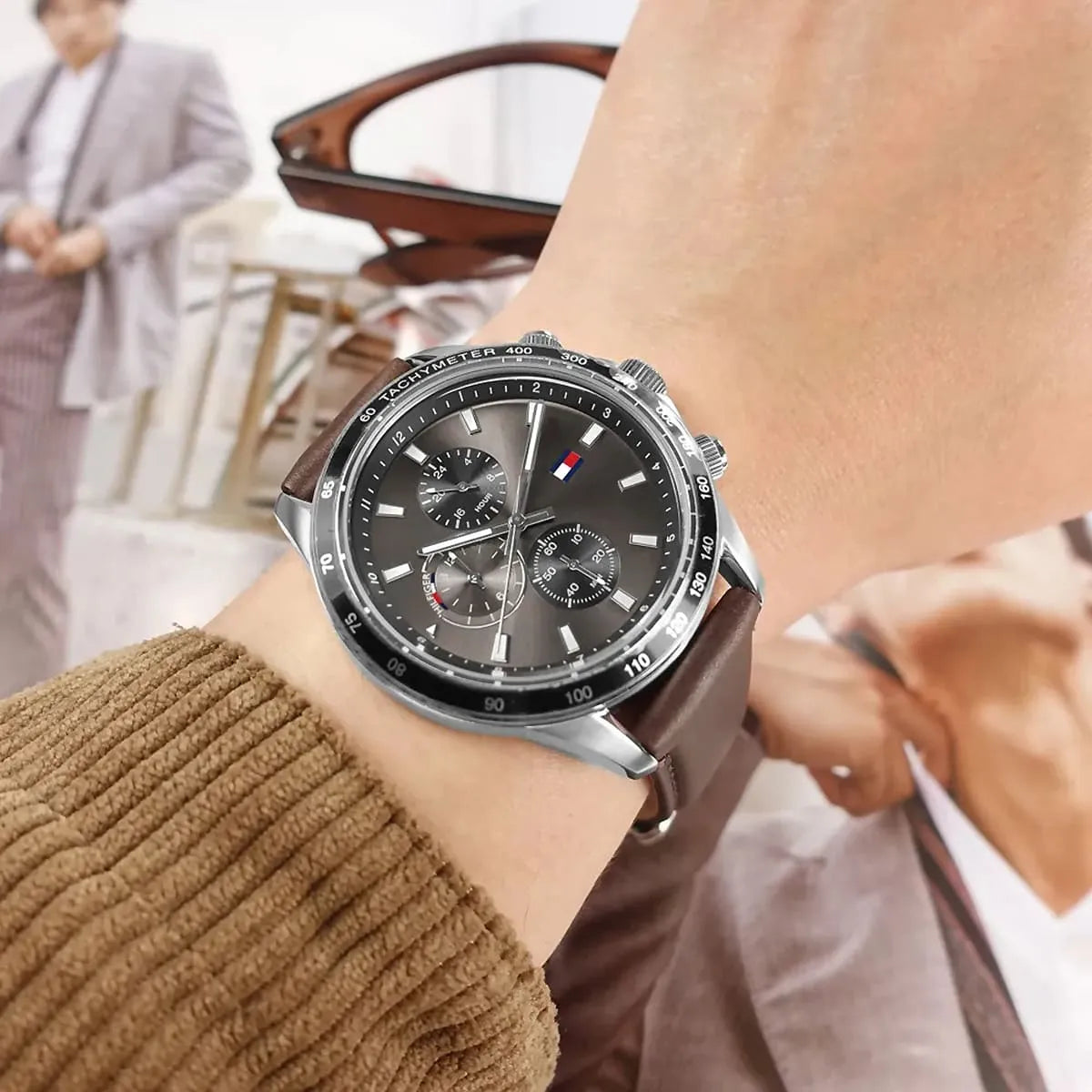 Tommy Hilfiger chronograph watch on wrist with brown leather strap