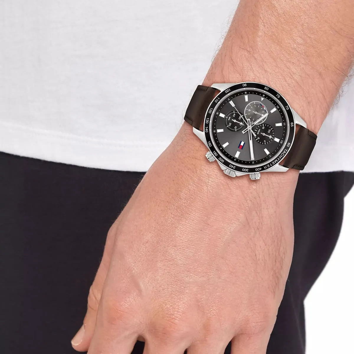 Men's wrist wearing Tommy Hilfiger 1792015 chronograph watch with brown strap