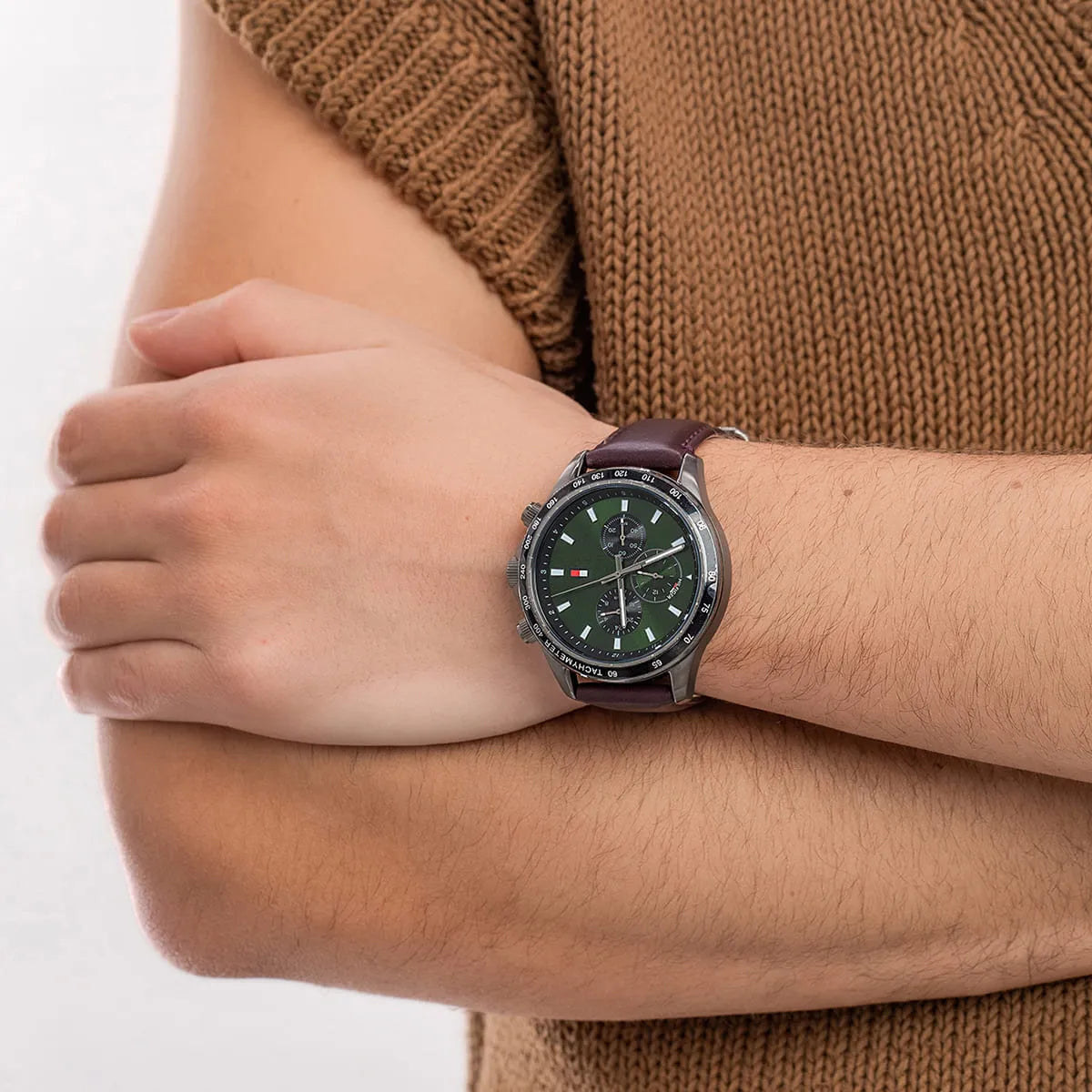 Tommy Hilfiger Miles men's chronograph watch worn on wrist with tan sweater